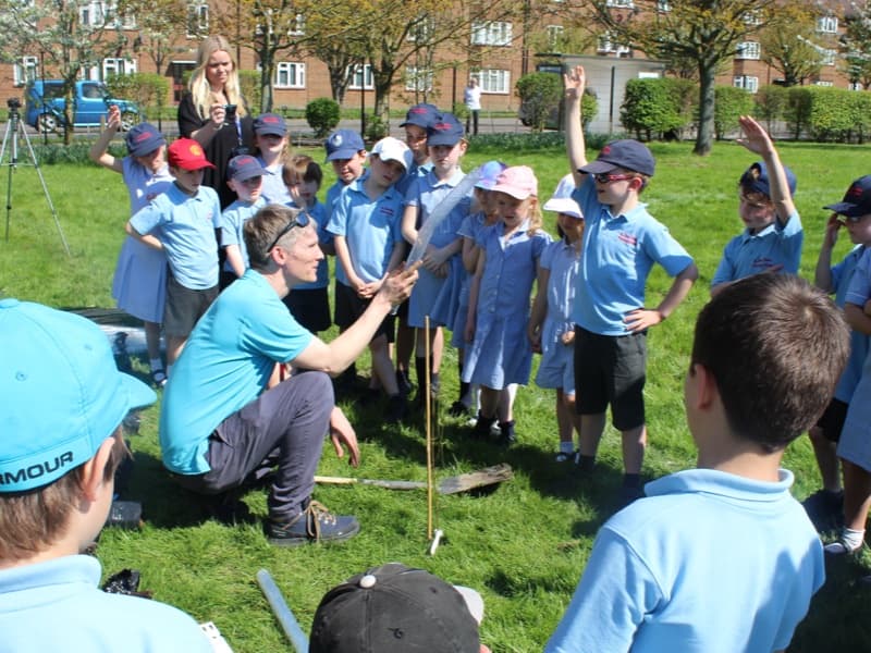 Team members planting native saplings together
